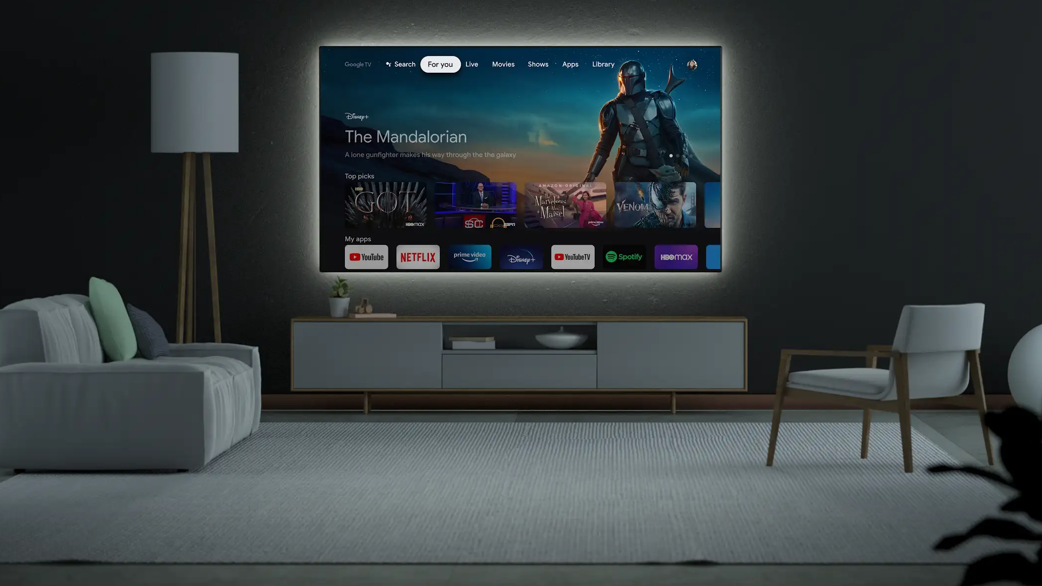 A living room with TV featuring the Google TV interface.